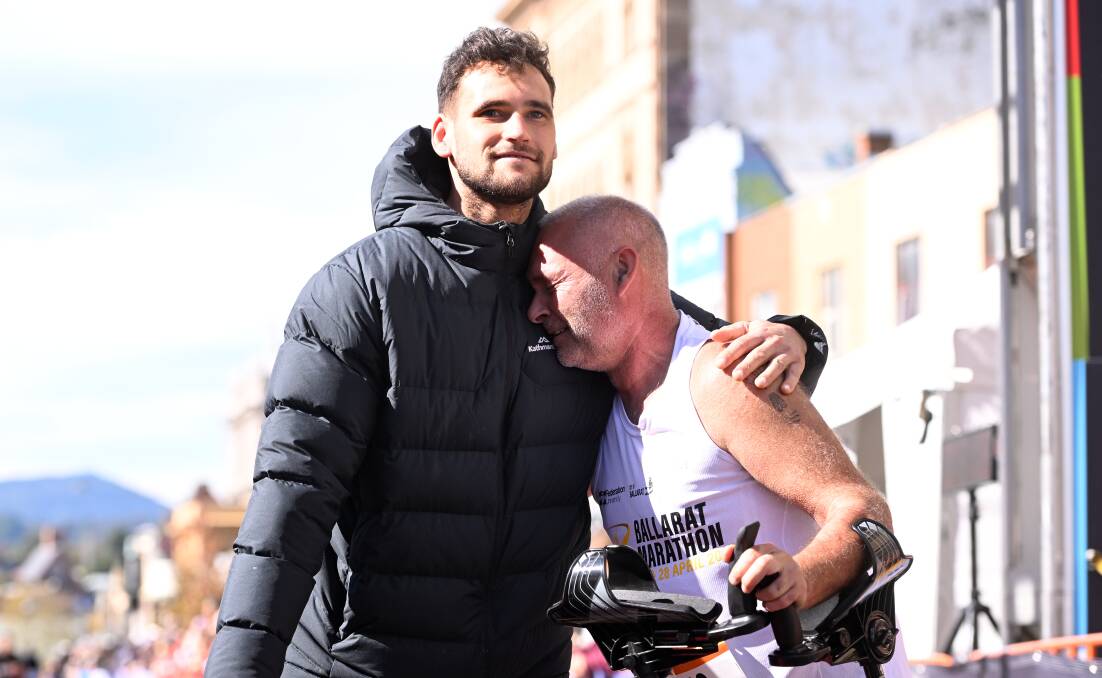 An emotional Mick Marshall with his support team member Aiden Domic (left) after finishing the half marathon and retiring from running. Picture by Adam Trafford