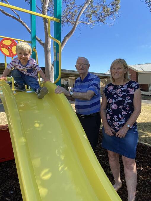 FUN: Generations enjoy time at new playground at Eventide Homes. Resident Ken Stewart with daughter Gayle Streeter and 18 month old great grandson Elijah Fletcher.