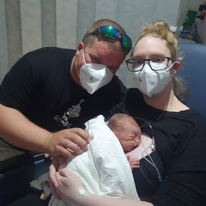 New parents Scott and Kimberley cuddle Lucas in hospital after his premature birth. Picture supplied