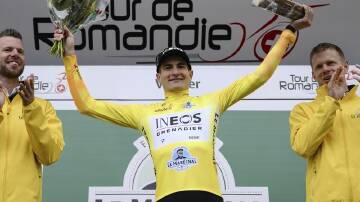 Carlos Rodriguez on the winner's podium at the Tour de Romandie in Vernier, Switzerland. (AP PHOTO)